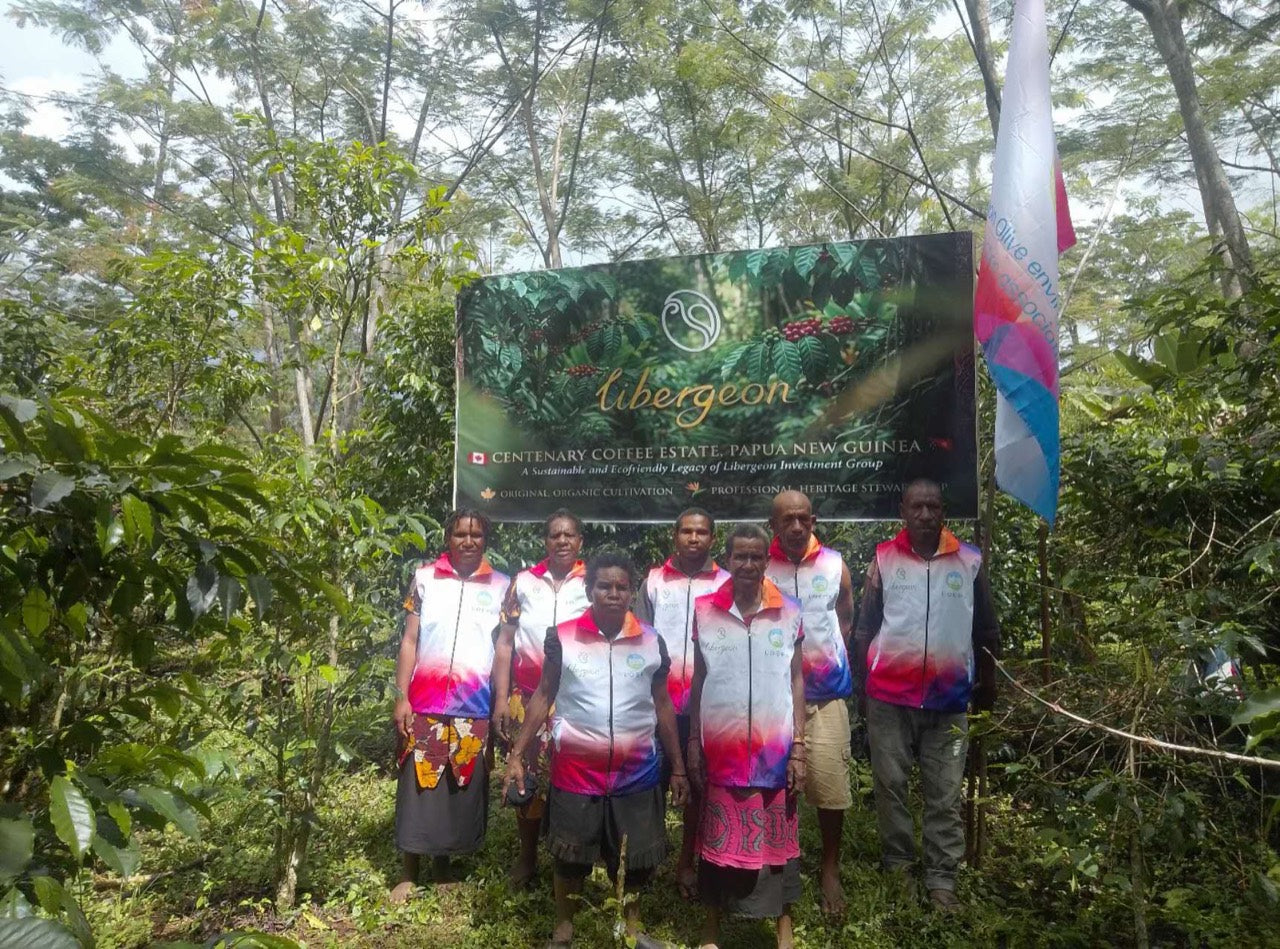 Association members with the estate sign and association flag